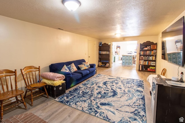 1471 W Stern Dr S, Taylorsville, UT 84123 - living area featuring wood finished floors and a textured ceiling