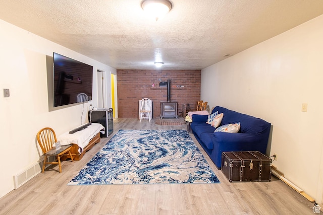 1471 W Stern Dr S, Taylorsville, UT 84123 - living room with a wood stove, a textured ceiling, and wood finished floors