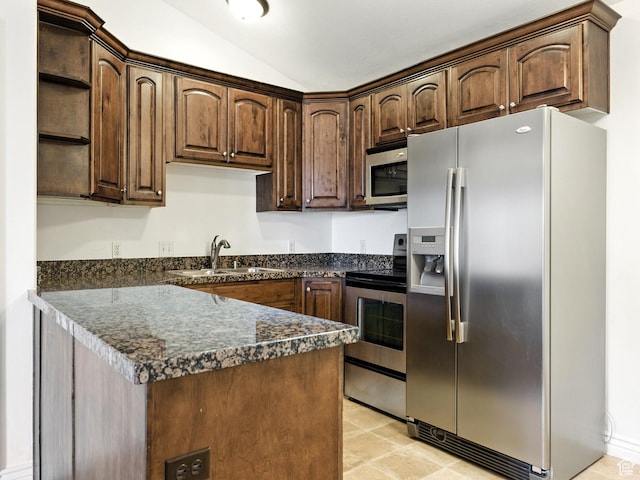 343 S 1000 W Unit 301, Pleasant Grove, UT 84062 - kitchen with appliances with stainless steel finishes, dark countertops, open shelves, vaulted ceiling, and dark brown cabinets