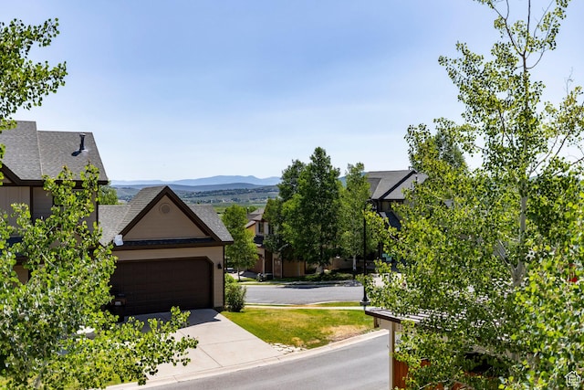 5596 N Oslo Ln, Park City, UT 84098 - exterior space featuring concrete driveway, a garage, and a mountain view