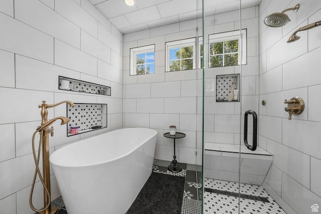 10617 S Split Rock Dr, South Jordan, UT 84009 - bathroom featuring tile walls, a shower stall, a soaking tub, and tile patterned floors