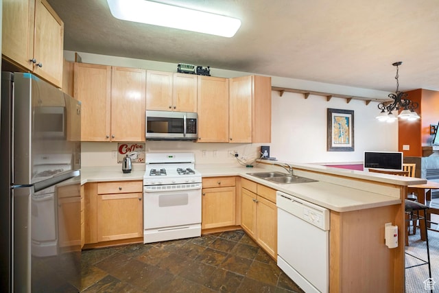 6605 N 2200 W Unit E205, Park City, UT 84098 - kitchen featuring appliances with stainless steel finishes, light brown cabinets, a peninsula, and light countertops