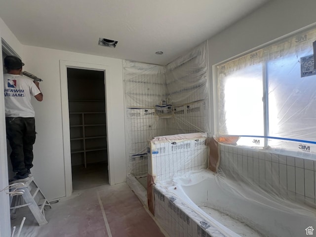 643 W Summerhill Ln, Centerville, UT 84014 - bathroom featuring a bath, a shower, and a walk in closet