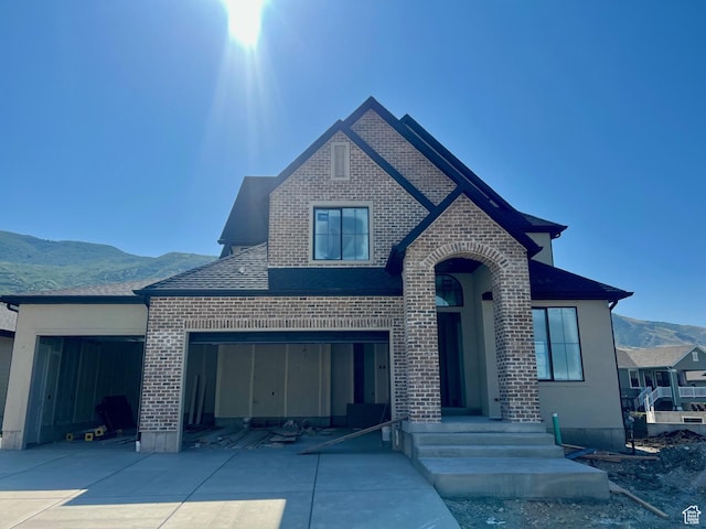 643 W Summerhill Ln, Centerville, UT 84014 - view of front of house with brick siding, a mountain view, concrete driveway, and a garage