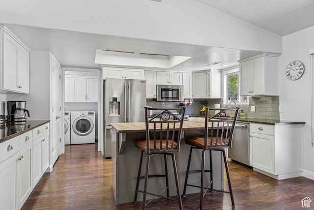 1755 E 2370 S, St George, UT 84790 - kitchen featuring stainless steel appliances, washer and dryer, backsplash, and dark wood-style floors