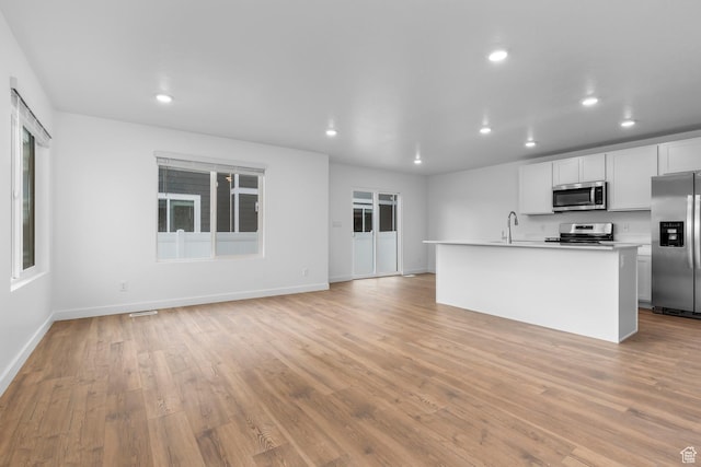 554 W 1870 S Unit 1194, Provo, UT 84601 - kitchen featuring appliances with stainless steel finishes, recessed lighting, light wood-style flooring, light countertops, and a kitchen island with sink
