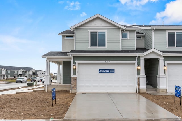 554 W 1870 S Unit 1194, Provo, UT 84601 - view of front of property with a garage, driveway, a shingled roof, and a porch