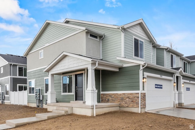 554 W 1870 S Unit 1194, Provo, UT 84601 - view of property featuring a garage, concrete driveway, covered porch, and stone siding