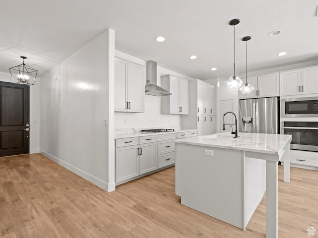 928 S 120 W, American Fork, UT 84003 - kitchen featuring wall chimney exhaust hood, stainless steel appliances, light wood-type flooring, a chandelier, and recessed lighting
