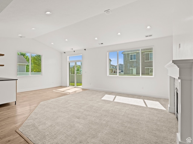 928 S 120 W, American Fork, UT 84003 - unfurnished living room with lofted ceiling, light wood-type flooring, a fireplace with flush hearth, and recessed lighting