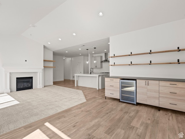 928 S 120 W, American Fork, UT 84003 - kitchen with beverage cooler, open shelves, wall chimney exhaust hood, open floor plan, and light wood-style floors
