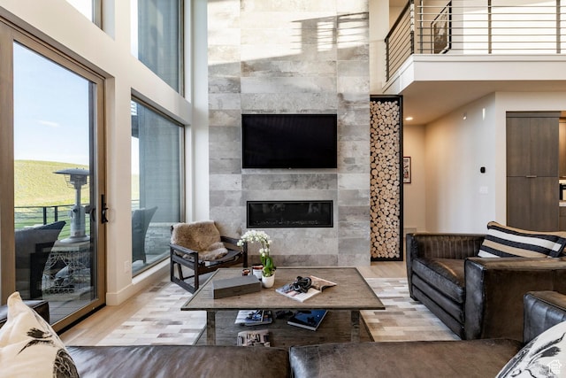 6836 Golden Bear Loop W, Park City, UT 84098 - living area featuring a fireplace, a high ceiling, and wood finished floors