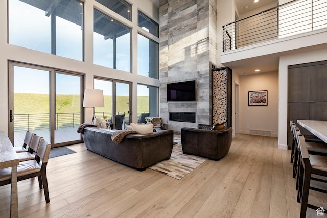6836 Golden Bear Loop W, Park City, UT 84098 - living area with a towering ceiling, a fireplace, and light wood-style floors