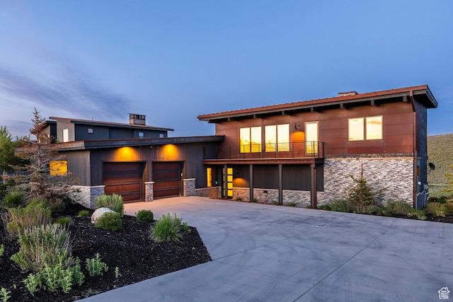 6836 Golden Bear Loop W, Park City, UT 84098 - view of front facade with stone siding, a balcony, a garage, and driveway