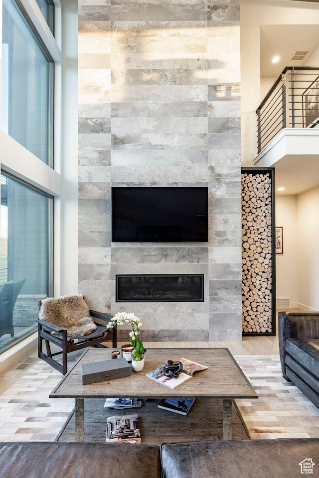 6836 Golden Bear Loop W, Park City, UT 84098 - living area with a high end fireplace, wood finished floors, a towering ceiling, and plenty of natural light