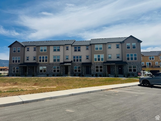 1650 N Main St Unit 126, Layton, UT 84041 - view of property featuring stone siding, board and batten siding, and a front yard