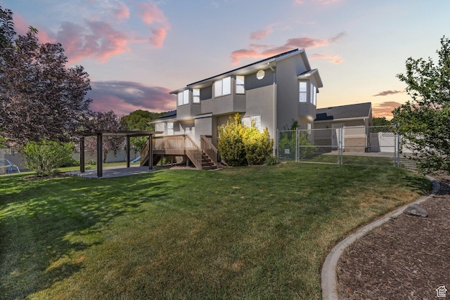 11783 S Stone Crest Ln W, Riverton, UT 84065 - back of property at dusk with stairs, stucco siding, a gate, and a wooden deck