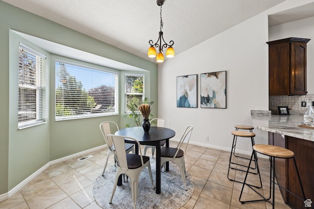 11783 S Stone Crest Ln W, Riverton, UT 84065 - dining space featuring light tile patterned floors, a chandelier, lofted ceiling, and a textured ceiling