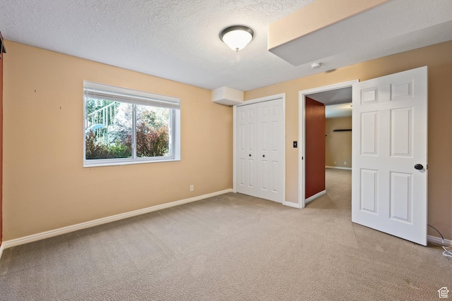 11783 S Stone Crest Ln W, Riverton, UT 84065 - unfurnished bedroom featuring carpet flooring, a closet, and a textured ceiling