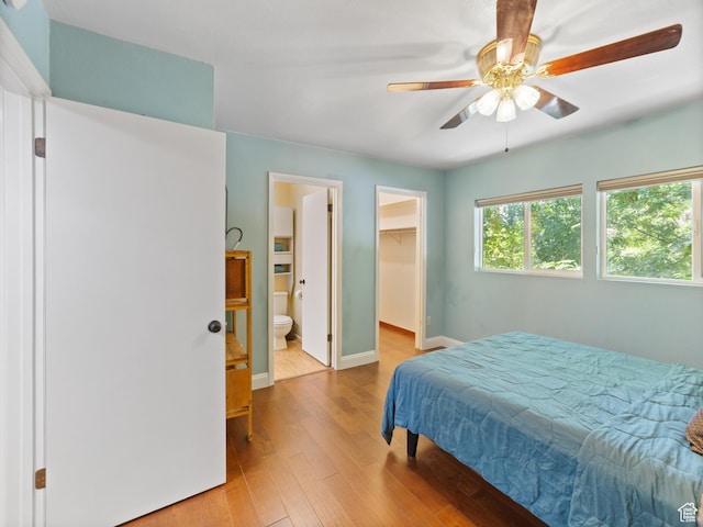 684 N Mccormick Blvd, Moab, UT 84532 - bedroom featuring wood finished floors, a spacious closet, ceiling fan, a closet, and connected bathroom