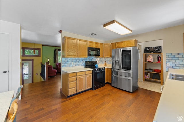 684 N Mccormick Blvd, Moab, UT 84532 - kitchen with black appliances, light countertops, dark wood-type flooring, and backsplash