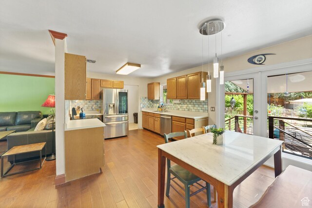 684 N Mccormick Blvd, Moab, UT 84532 - kitchen with stainless steel appliances, light countertops, backsplash, french doors, and light wood-type flooring