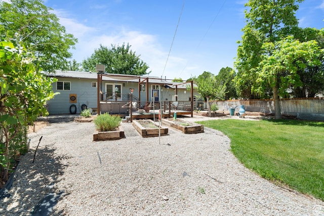 684 N Mccormick Blvd, Moab, UT 84532 - rear view of property with a vegetable garden, a fenced backyard, a patio area, and a wooden deck