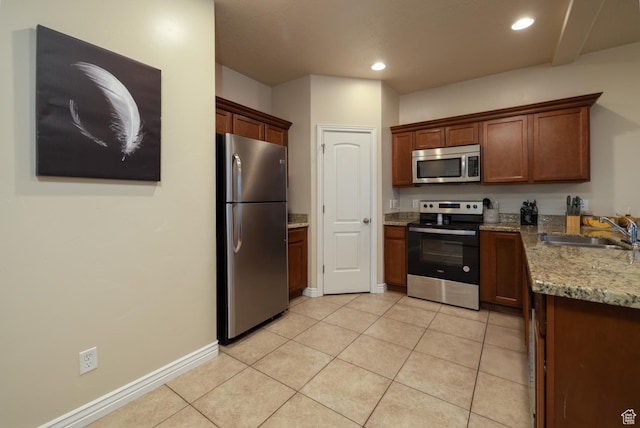 361 E 535 S, Vernal, UT 84078 - kitchen with appliances with stainless steel finishes, light tile patterned floors, light stone countertops, and recessed lighting