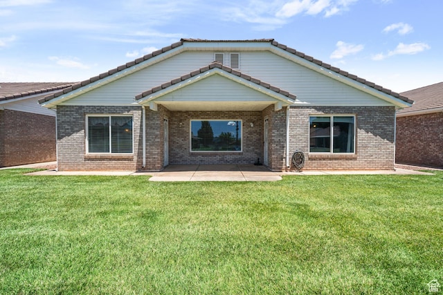 805 S River Rd Unit 65, St George, UT 84790 - back of property featuring a patio, a yard, brick siding, and a tiled roof