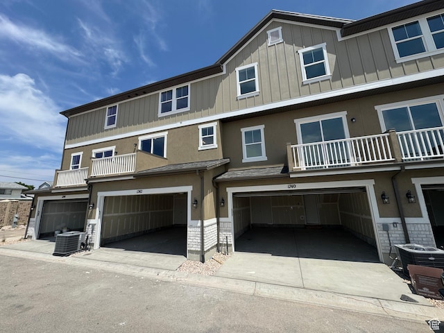 1682 N 1600 W Unit 124, Layton, UT 84041 - view of front of property with an attached garage, a balcony, board and batten siding, and driveway