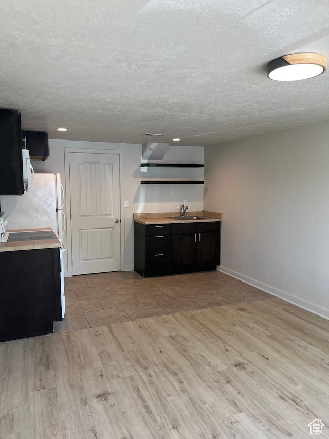 1194 W 400 S, Orem, UT 84058 - kitchen featuring light wood finished floors, light countertops, white appliances, a textured ceiling, and open shelves
