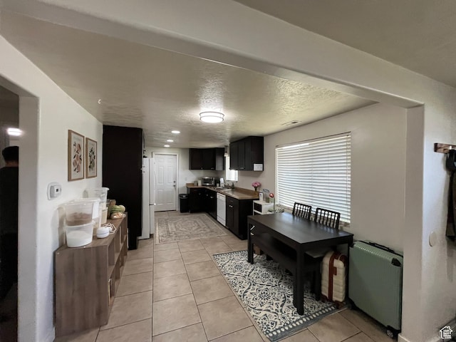 1194 W 400 S, Orem, UT 84058 - kitchen featuring dark cabinetry, white appliances, light tile patterned floors, a textured ceiling, and radiator heating unit