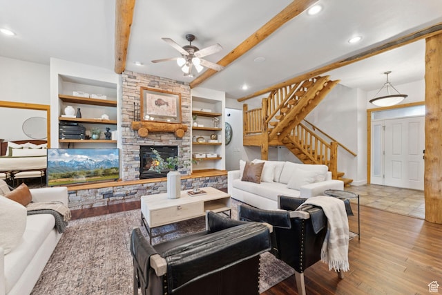 92 W Village Ct, Midway, UT 84049 - living area featuring stairs, beam ceiling, ceiling fan, built in features, and a stone fireplace