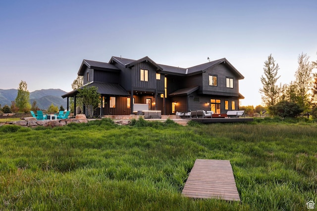 4746 Old Meadow Ln, Park City, UT 84098 - rear view of property featuring board and batten siding, a patio, a mountain view, and outdoor lounge area