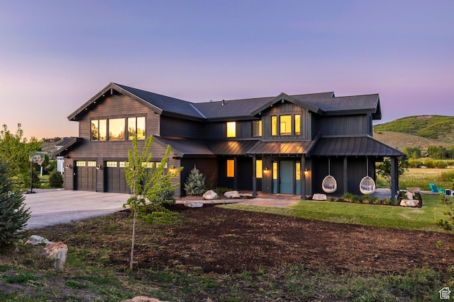 4746 Old Meadow Ln, Park City, UT 84098 - view of front of property featuring an attached garage, driveway, a porch, a yard, and a metal roof