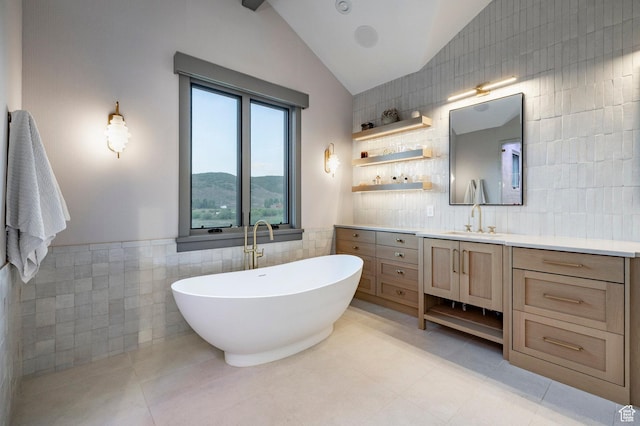 4746 Old Meadow Ln, Park City, UT 84098 - bathroom with tile walls, vanity, lofted ceiling, a soaking tub, and tile patterned floors