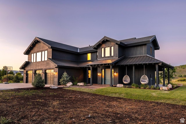 4746 Old Meadow Ln, Park City, UT 84098 - view of front of house featuring a garage, driveway, a lawn, and board and batten siding
