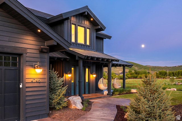 4746 Old Meadow Ln, Park City, UT 84098 - property entrance featuring board and batten siding, a standing seam roof, a metal roof, and a mountain view