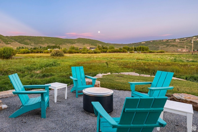 4746 Old Meadow Ln, Park City, UT 84098 - patio terrace at dusk with a mountain view, a view of rural / pastoral area, and a fire pit
