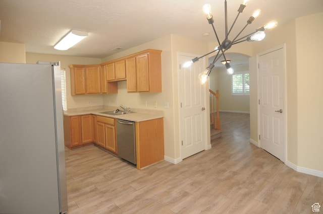 1511 W Leonardo Ln Unit D, West Valley City, UT 84119 - kitchen featuring freestanding refrigerator, stainless steel dishwasher, light countertops, light wood-style flooring, and a chandelier