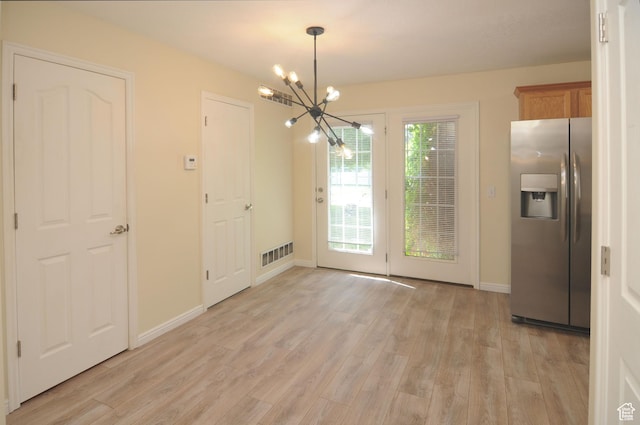 1511 W Leonardo Ln Unit D, West Valley City, UT 84119 - unfurnished dining area featuring a chandelier and light wood-type flooring