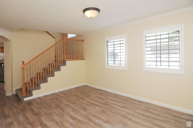 1511 W Leonardo Ln Unit D, West Valley City, UT 84119 - below grade area with wood finished floors, arched walkways, stairs, and ornamental molding
