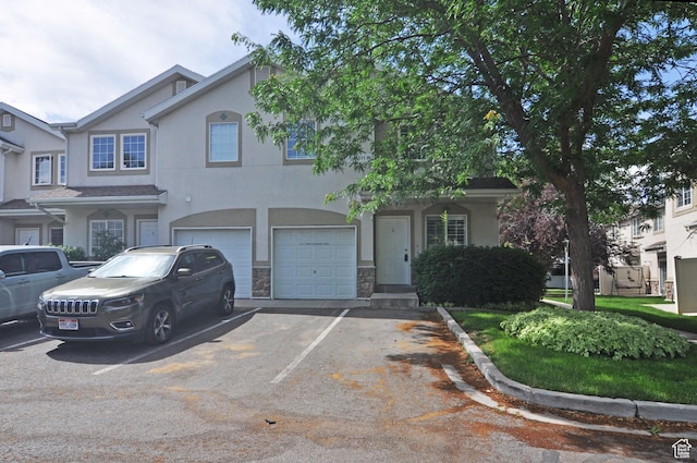 1511 W Leonardo Ln Unit D, West Valley City, UT 84119 - multi unit property featuring stucco siding, a garage, asphalt driveway, and stone siding
