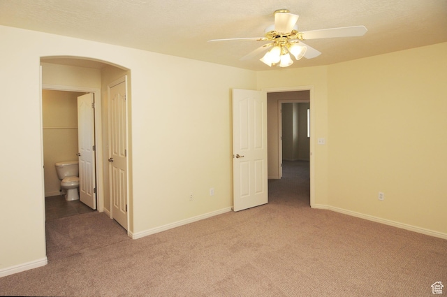 1511 W Leonardo Ln Unit D, West Valley City, UT 84119 - spare room featuring light carpet, arched walkways, and ceiling fan