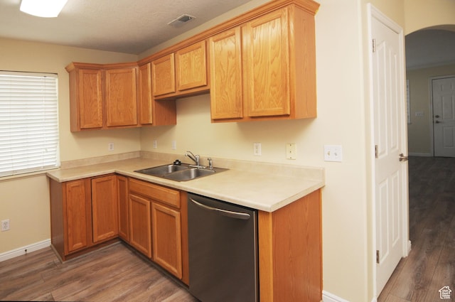 1511 W Leonardo Ln Unit D, West Valley City, UT 84119 - kitchen with dishwasher, wood finished floors, light countertops, and arched walkways