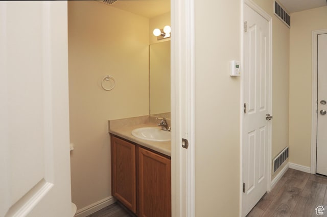 1511 W Leonardo Ln Unit D, West Valley City, UT 84119 - bathroom featuring vanity and wood finished floors