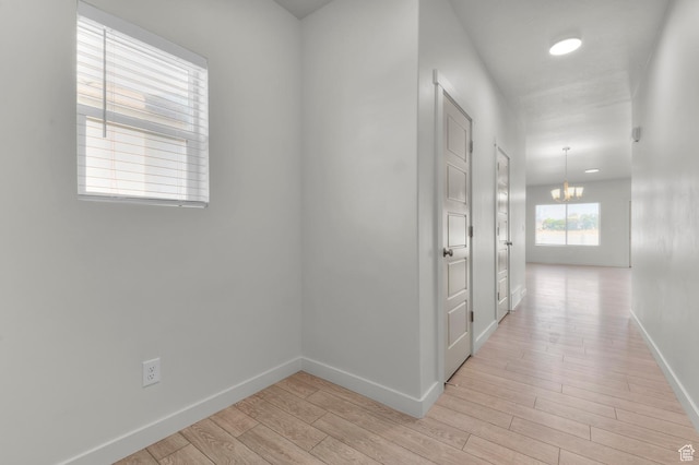 421 W Domain Ln, Grantsville, UT 84029 - hall featuring light wood finished floors and a chandelier