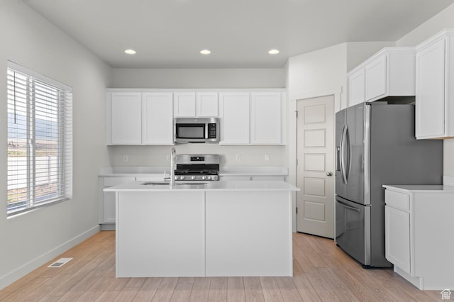 421 W Domain Ln, Grantsville, UT 84029 - kitchen with stainless steel appliances, white cabinets, light wood-style floors, and recessed lighting
