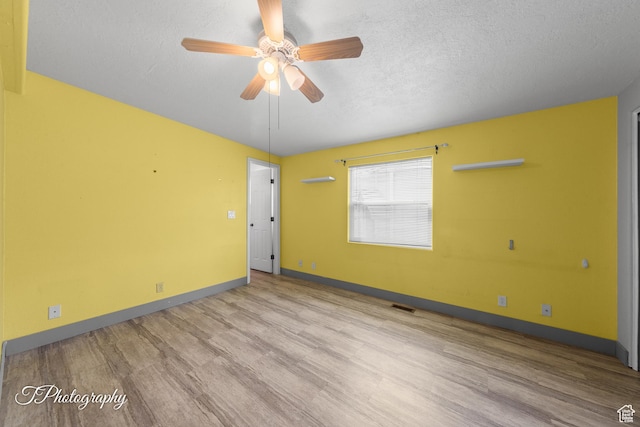 1160 E Telegraph Unit 227, Washington, UT 84780 - unfurnished room with wood finished floors, a ceiling fan, and a textured ceiling