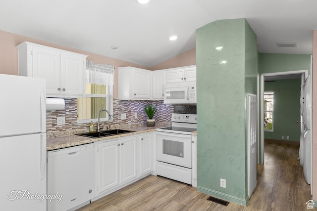 1160 E Telegraph Unit 227, Washington, UT 84780 - kitchen with white appliances, lofted ceiling, light wood-style floors, backsplash, and white cabinetry